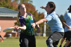 Alison Fowler, junior in marine science, passes the disc during the Women's Club Ultimate Wolfpack Invitational ultimate frisbee tournament Saturday, Oct. 25, 2014. Both men's and women's clubs hosted tournaments over the weekend, with teams from UNC-Chapel Hill, UNC-Greensboro, UNC-Asheville, Duke, Elon, Applachain State, and Virginia were in attendance. The men's and women's ultimate teams are two of 44 different club sports at N.C. State, offering students the opportunity to compete in various activities, including cycling, fencing, sailing, equestrian, water polo, and rugby. By: John Joyner