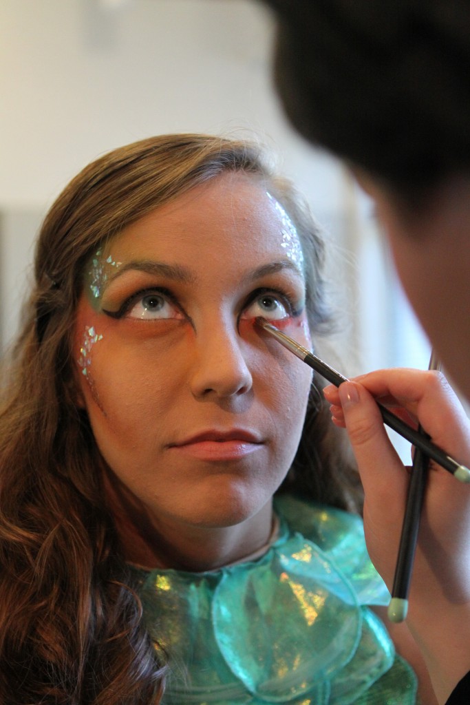 Shayna Yeager, a model in Art2Wear, has makeup applied during the pre-show routine. Yeager was a model in "Creatures of the Deep," a collection designed by Sarah Edens, a junior in fashion and textile management, and Lindsey Sherrill, a senior in fashion and textile management. By:  Joannah Irvin