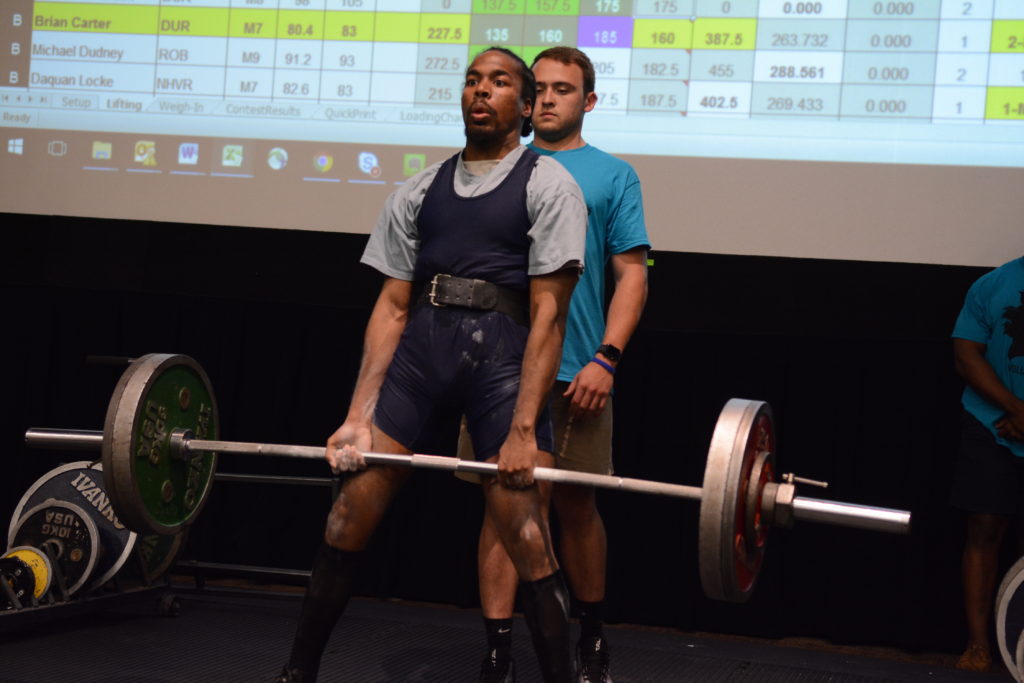 [Special Olympian Brian Carter demonstrates a deadlift]
